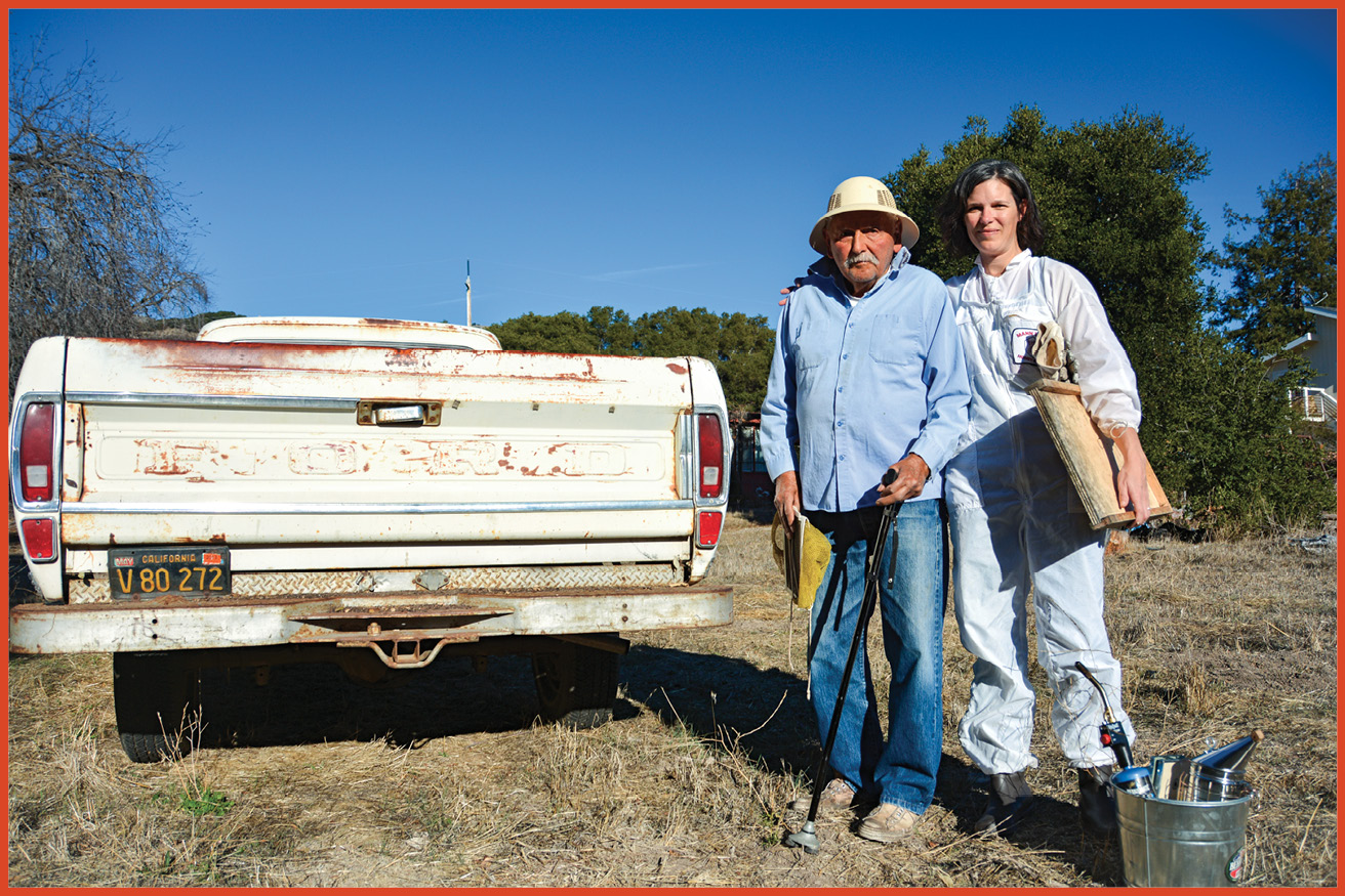 image of grandfather and grown granddaughter standing outside next to a truck