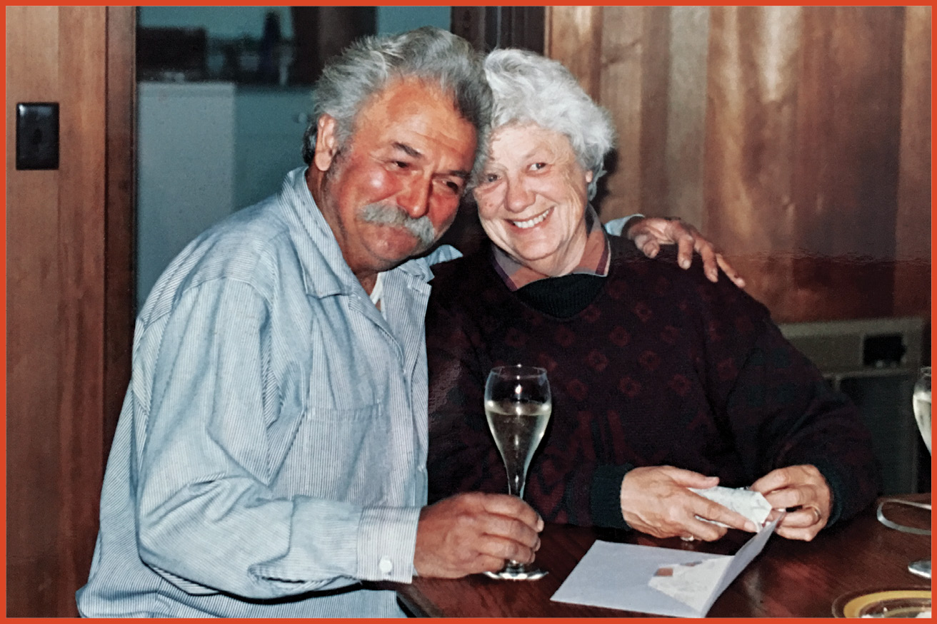 image of an elderly husband of wife holding wine glasses