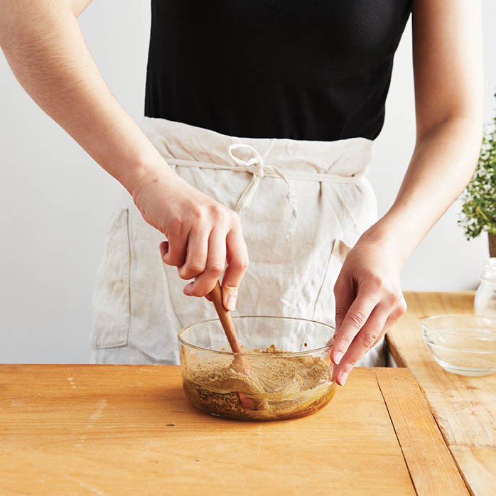 Stirring the powder and honey.