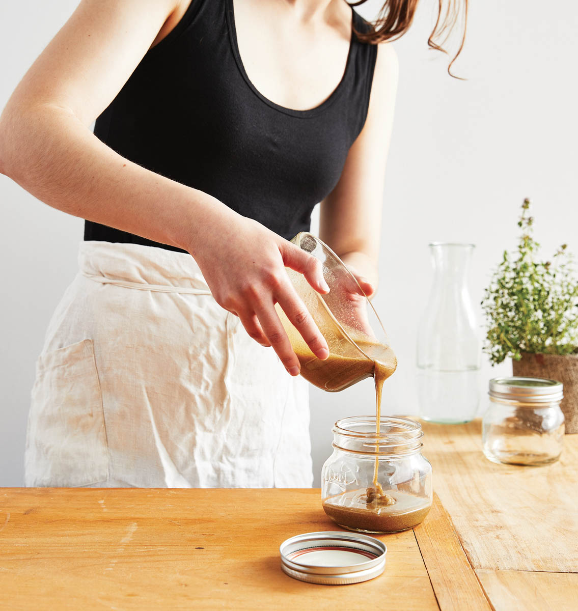 Pouring the mixed honey into a jar.