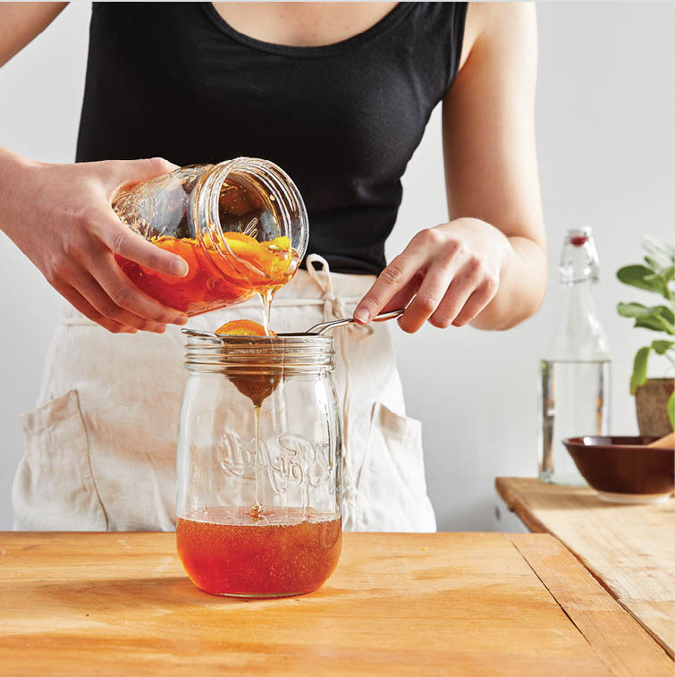 Straining the mixed honey.