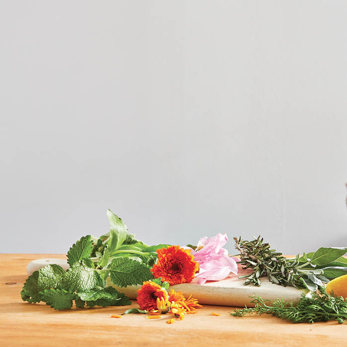 A spread of freshly picked herbs and flowers.