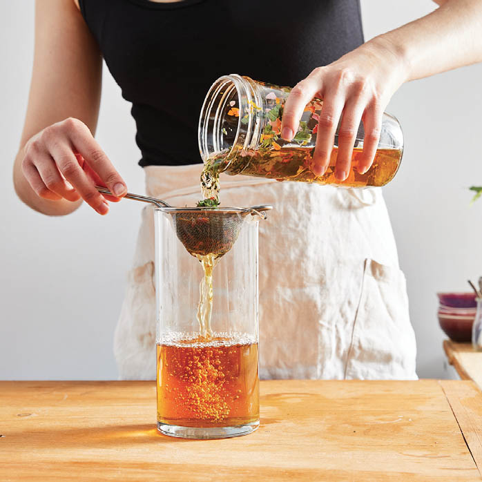 Straining the mixed apple cider vinegar.