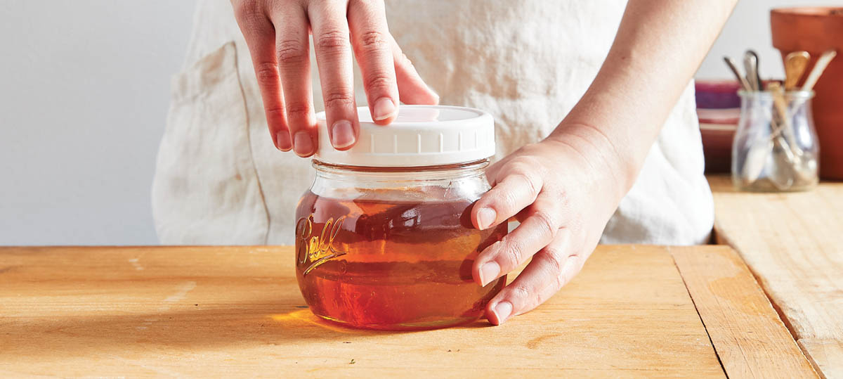 Sealing the jar of infused vinegar.