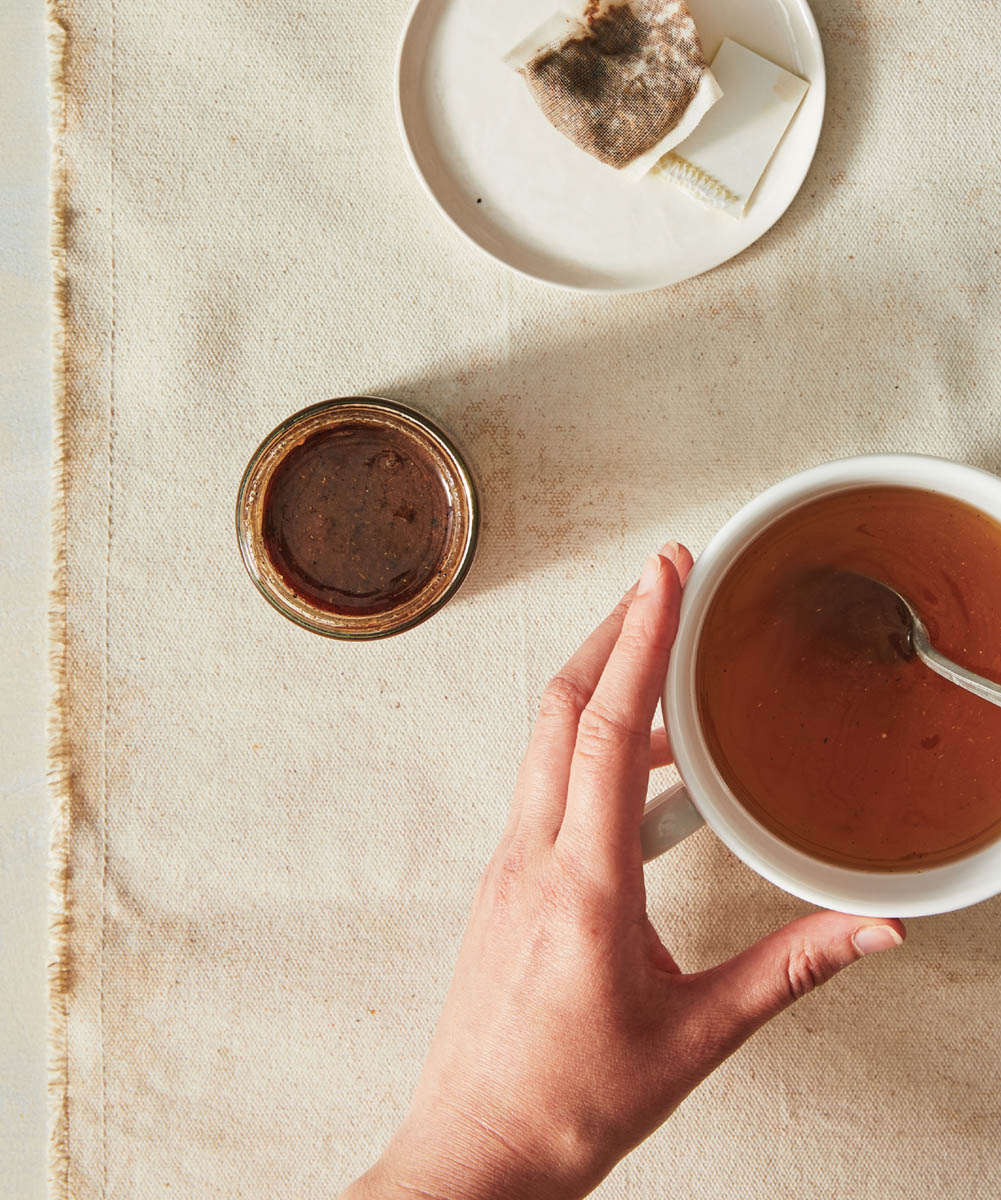 A bowl of honey with a jar of well fast honey spread.