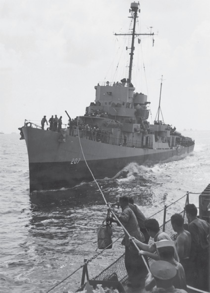 Loneliness and homesickness were common among sailors who were at sea for long periods. They eagerly looked for news from home and lined up when the mail sacks arrived. Here the USS Liddle comes alongside its sister ship, the USS Kephart, to transfer a sack of mail. Using a rope and pulley system, sacks of mail, supplies, and even people were transferred between ships. Photo taken by Harold S. Deal; courtesy Jeff Deal