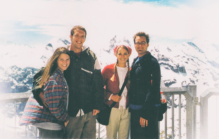 Donna, Patrick, Kirstin, and Justin pose for a photo in front of a snow-covered mountainside.