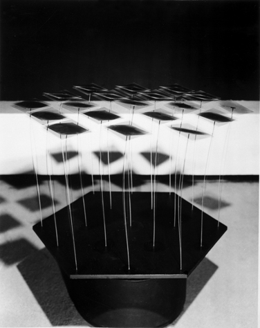 Figure 19 Wen-Ying Tsai Square Tops, 1967. Stainless steel rods with aluminum squares on plywood plate, electric motor, stroboscopic light, and electronic audio feedback control.