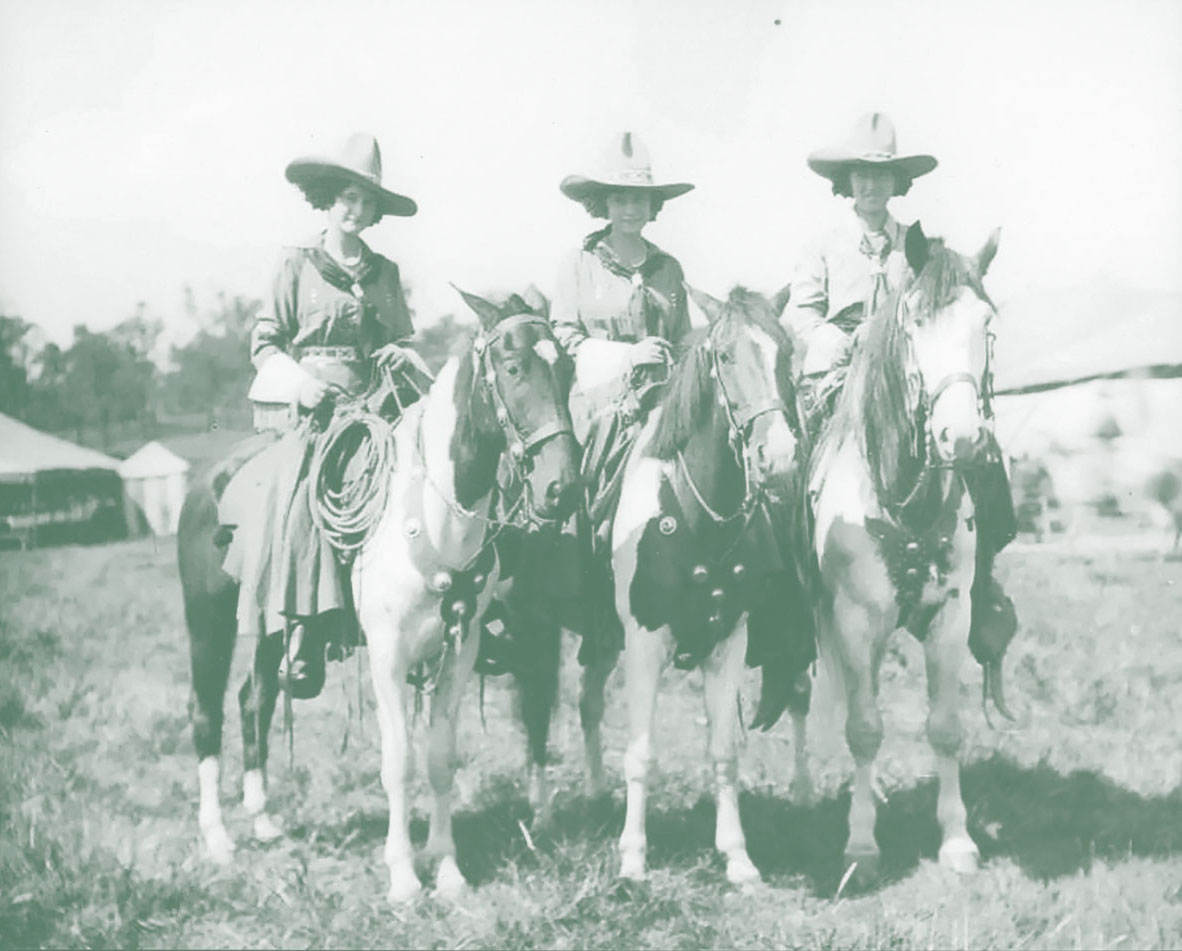 Photo of three cattlewomen on horses.