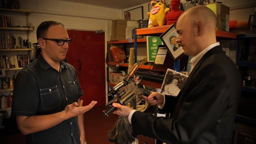 Cory Doctorow shows Brian David Johnson a ray gun