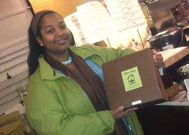 Rhonda Jones with a labeled cake box. COURTESY OF COCOA CINNAMON