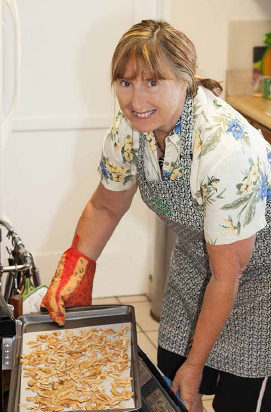 Barbara Preston removing tray of her Hana Lulu’s coconut candies from her oven. COURTESY OF HANA LULU’S CANDY