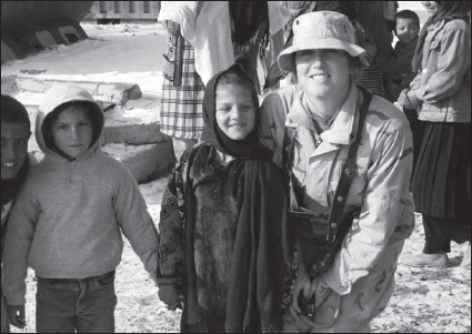 Courtney Senini interacting with Afghan children during a routine patrol in 200J. (Courtesy Courtney Senini)