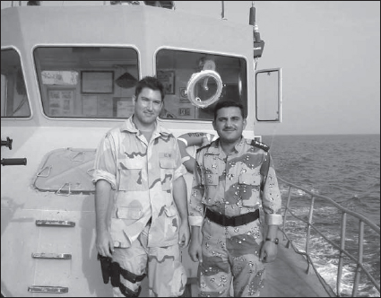 Travis Bode at sea in the Persian Gulf mentoring an Iraqi naval officer. (Courtesy Travis Bode)