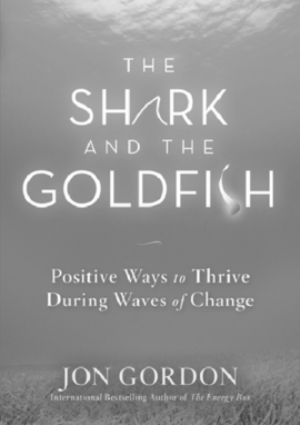 A cover page from Jon Gordon's “The Shark and the Goldfish” with a tag line “Positive ways to thrive during waves of change.”