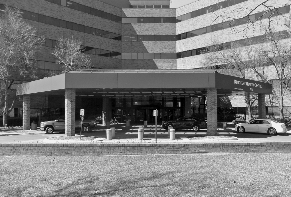 The photograph depicting the entrance area that is recognizable from a distance and provides shelter as drivers drop off and pick up patients.