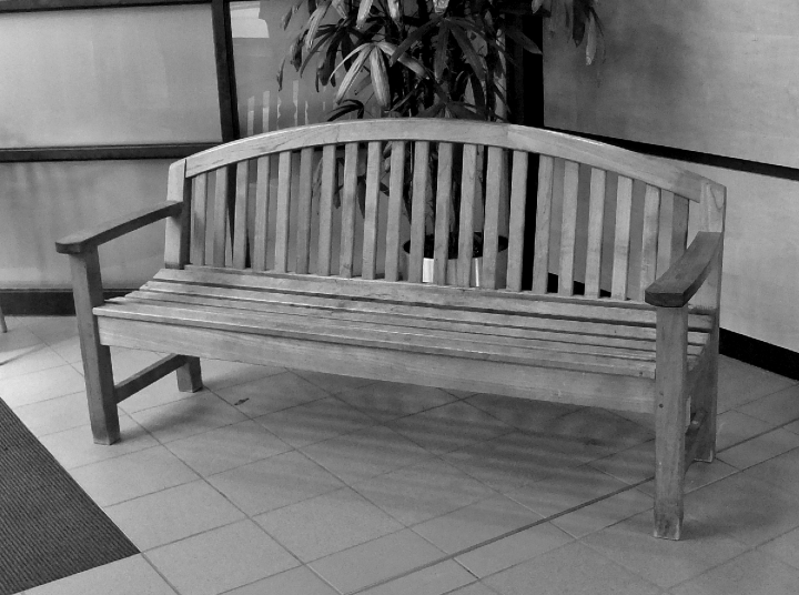 The photograph depicting benches featuring armrests and space under the seat make it easier for customers to sit and rise.