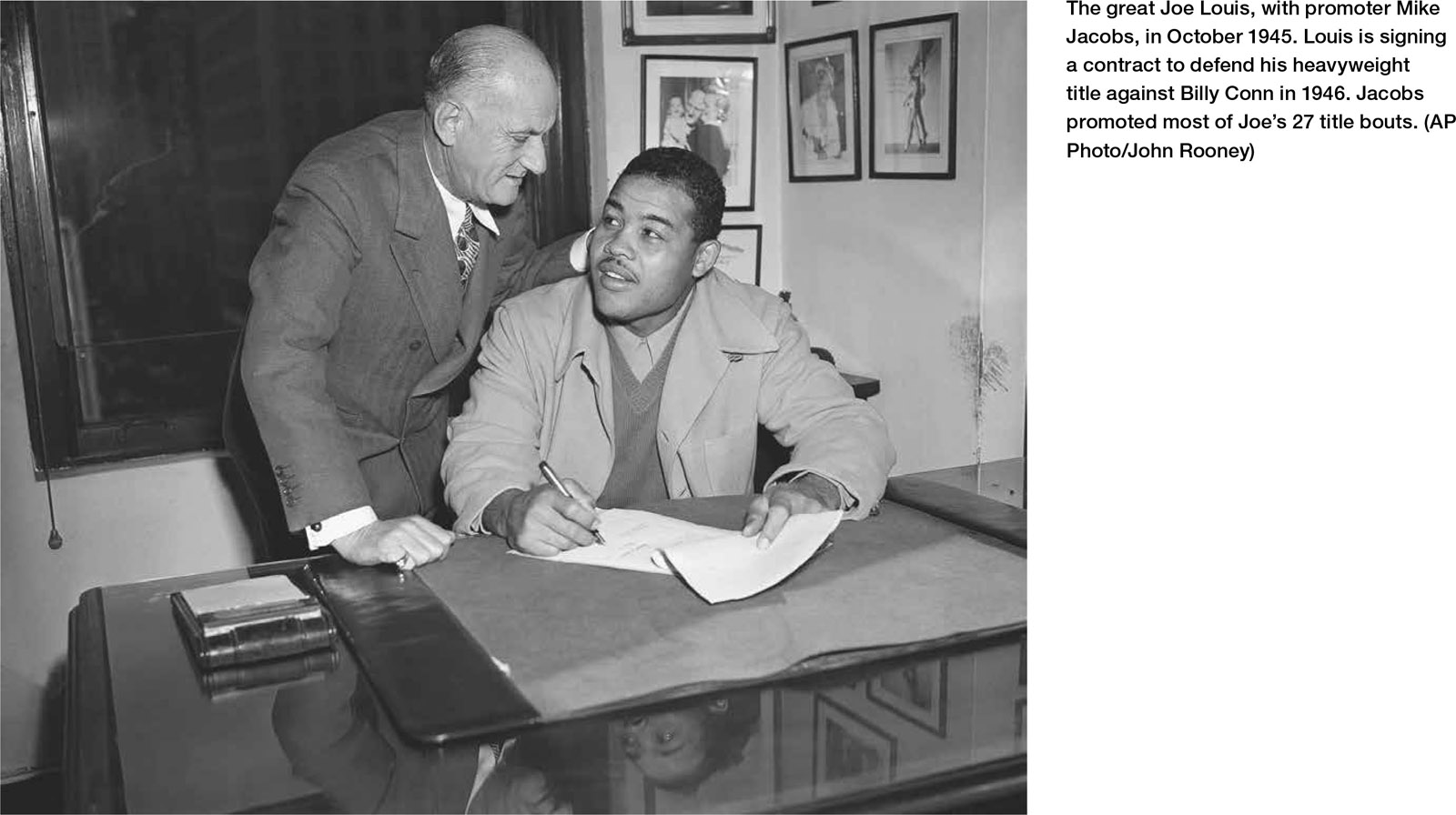 The great Joe Louis, with promoter Mike Jacobs, in October 1945. Louis is signing a contract to defend his heavyweight title against Billy Conn in 1946. Jacobs promoted most of Joe’s 27 title bouts. (AP Photo/John Rooney)