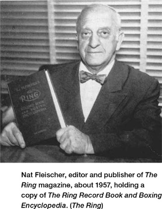 Nat Fleischer, editor and publisher of The Ring magazine, about 1957, holding a copy of The Ring Record Book and Boxing Encyclopedia. (The Ring)