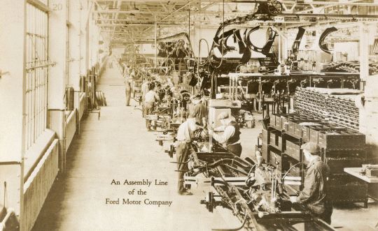 Photograph depicting an assembly line of the Ford motor company.