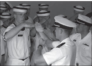 Within hours of arriving on Induction Day, Midshipman 4/C Richard Ferrari and other members of USNA 2002 learn how to render a salute. (Courtesy U.S. Naval Academy)