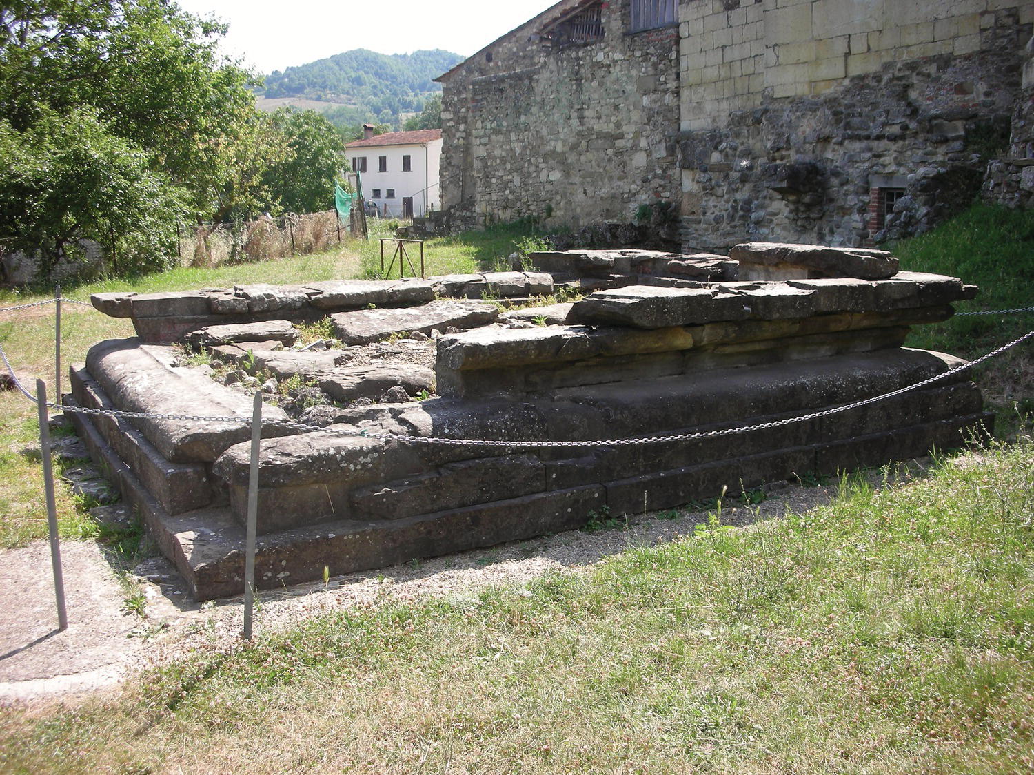 A photo of a monumental altar surrounded by a chain as fence.