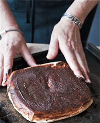 The finished block of cheese with the cocoa spread evenly distributed on top of it