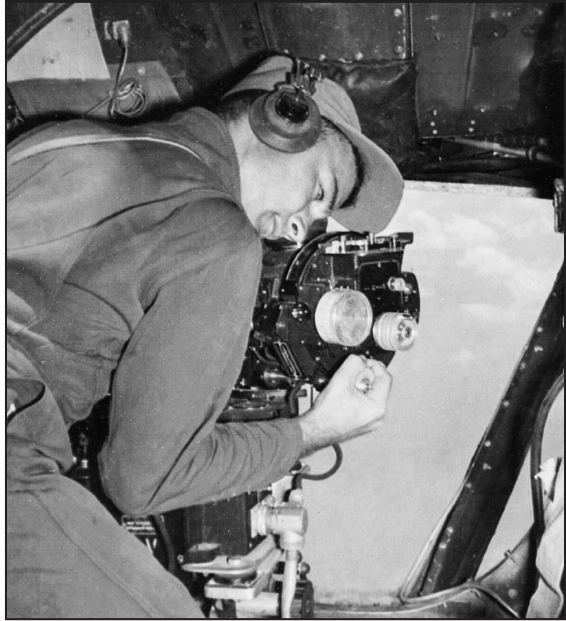 A bombardier working his bombsight.