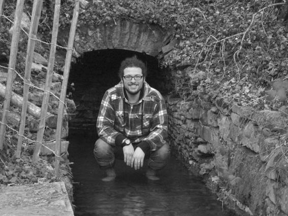 Jared crouching in St. Stephen's Spring