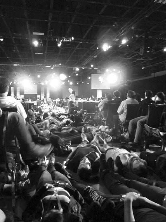 The Tony Robbins event with people lying on the floor in the aisles