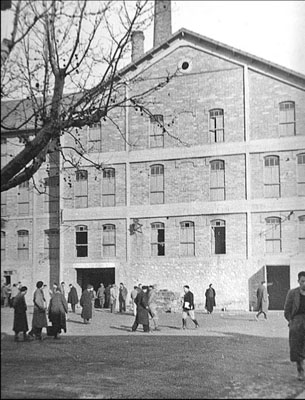 The courtyard of Camp des Milles, with the former brick factory in the background, circa 1941.