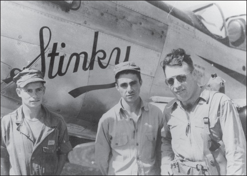 Col. Arthur R. DeBolt, commander of the 2nd ACG, stands in front of his personal aircraft, Stinky, with his armorer and crew chief. (U.S. Army Air Forces archives)