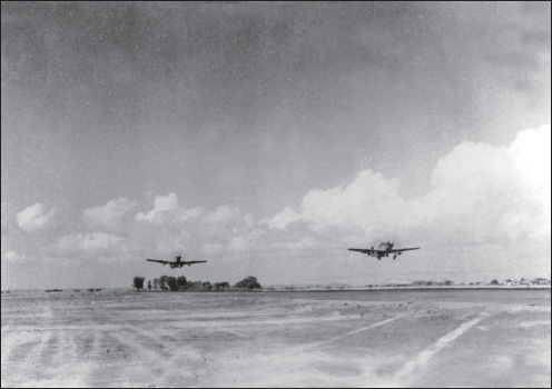 A pair of P-51s takes off from Cox’s Bazar on the 2nd ACG’s first combat mission, February 14, 1945. (U.S. Army Air Forces archives)