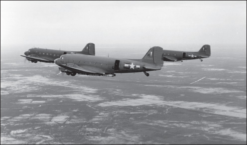 Carrying supply parapacks beneath their wings, a trio of 317th Troop Carrier Squadron C-47s near Rangoon. (U.S. Army Air Forces archives)