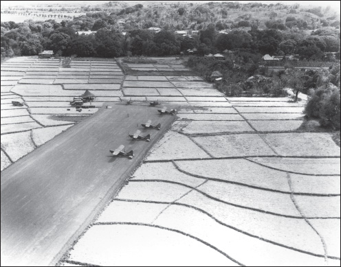 A typical light plane strip bulldozed out of rice paddies: At least one of the parked L-5s is from the 3rd ACG’s 159th Liaison Squadron. (U.S. Army Air Forces archives)