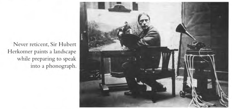 Never reticent, Sir Hubert Herkomer paints a landscape while preparing to speak into a phonograph.