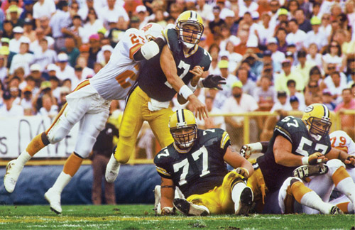 The Packers’ inability to run the ball during the 1991 season left Don Majkowski (7), Tony Mandarich (77), and Rich Moran (57) often exposed and having to pick themselves up off the turf. (courtesy of eau claire leader-telegram)