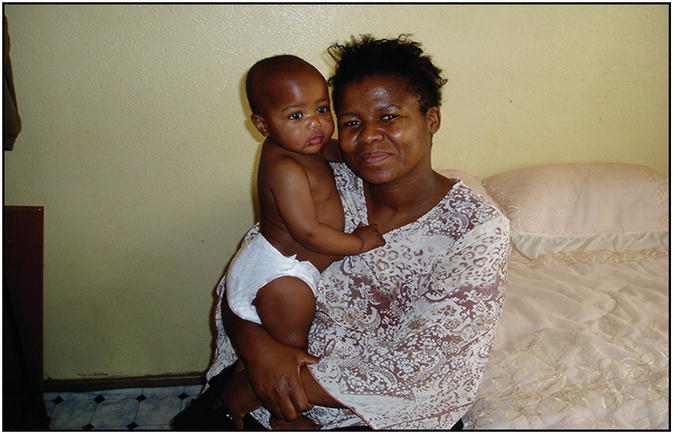 Photo of an African woman carrying her toddler.