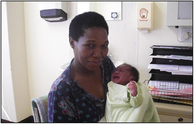 Photo of an African woman holding an infant.