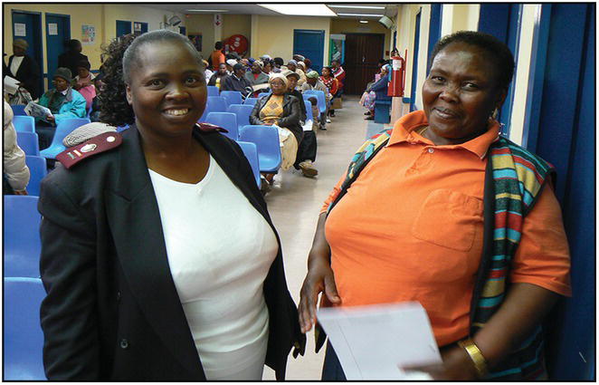 Photo of two African women in a waiting area.