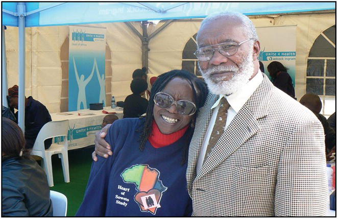 Photo of an African woman leaning against an elderly African man in suit.