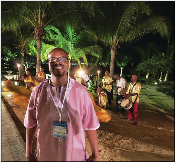 Photo of a male African delegate at an evening party.