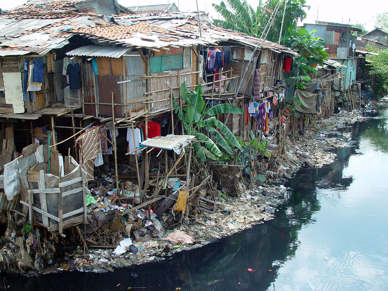 dilapidated housing, garbage strewn on streets