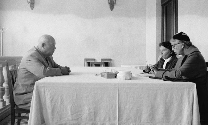 Eleanor and a translator sit across the table from a Soviet leader.