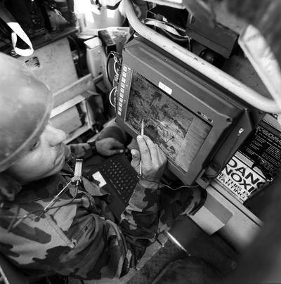 A soldier in the field using a command-and-control system built by Neil's team.