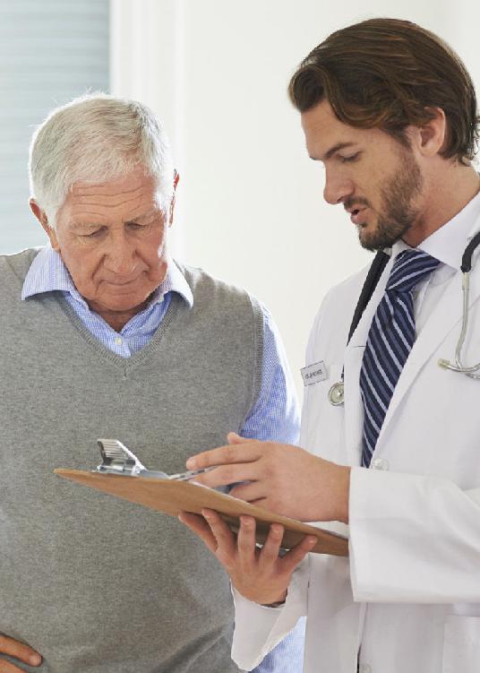 A photo showing a doctor going over test results with his patient.