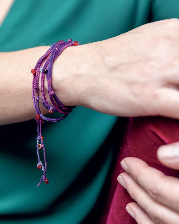 A woman wearing a beaded bracelet