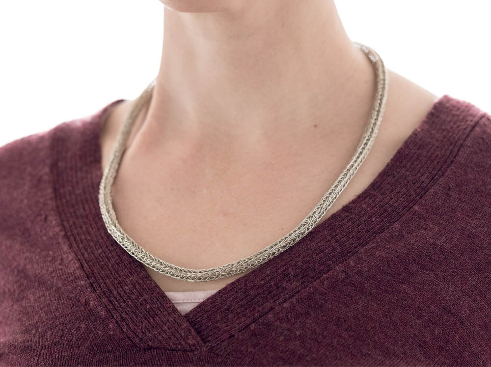 A woman wearing a freya chain necklace