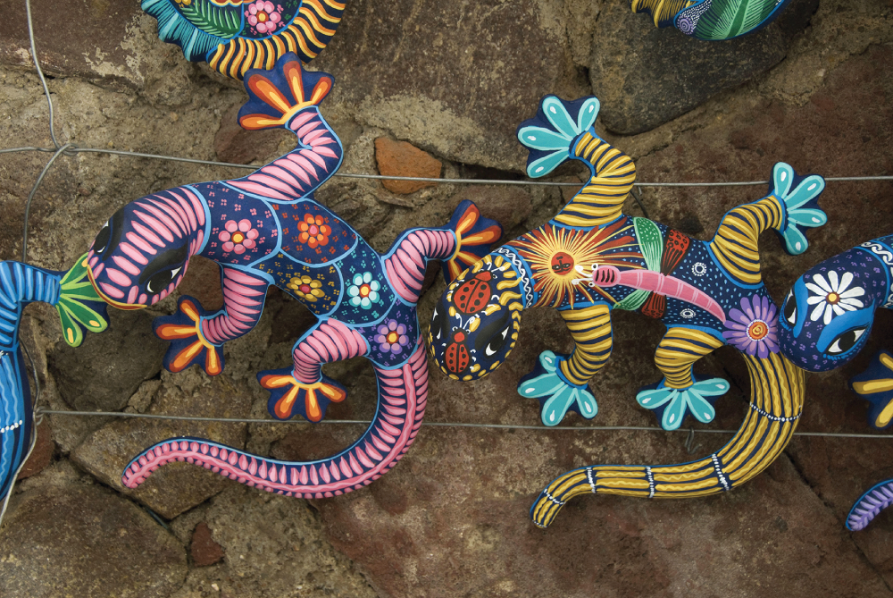 Photo depicts the colorful hand-crafted ceramic geckos.