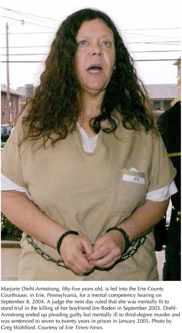 Marjorie Diehl-Armstrong, fifty-five years old, is led into the Erie County Courthouse, in Erie, Pennsylvania, for a mental competency hearing on September 8, 2004. A judge the next day ruled that she was mentally fit to stand trial in the killing of her boyfriend Jim Roden in September 2003. Diehl-Armstrong ended up pleading guilty but mentally ill to third-degree murder and was sentenced to seven to twenty years in prison in January 2005. Photo by Greg Wohlford. Courtesy of Erie Times-News.